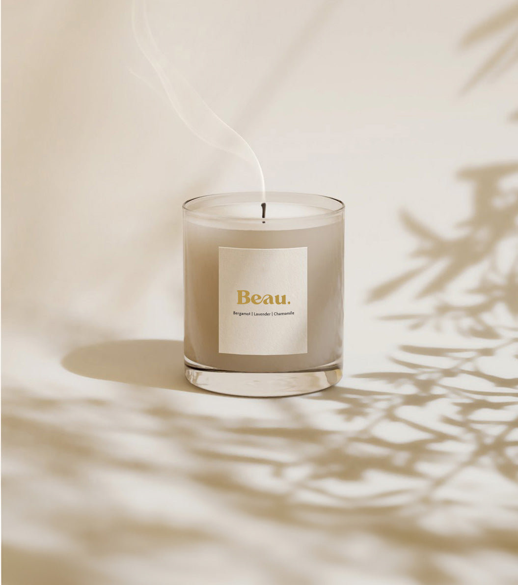 Image of Luxury Eco Soy Candle Smouldering in the shadow of a plant. 